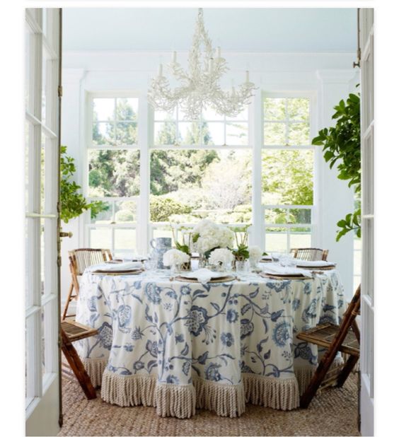 Aerin Lauder Hamptons breakfast room - Lee Jofa fabric - seagrass rug - white hydrangea - Samuel and Sons trim